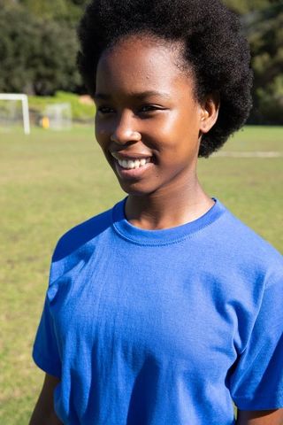 Teenage Soccer Player Smiling on Sunny Field