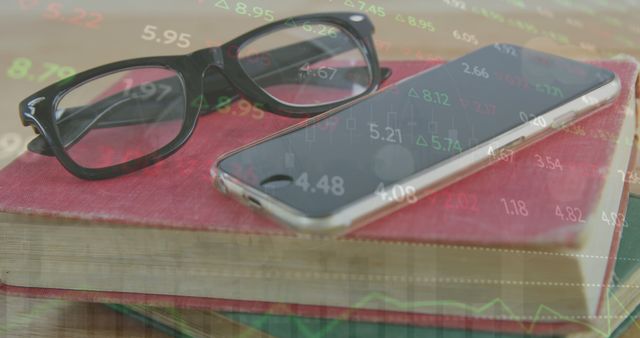 Close-up shots of a smartphone and glasses on a book with overlaid stock market data are great for articles about technology in finance, investment strategies, and the intersection of traditional and digital tools in the business world.