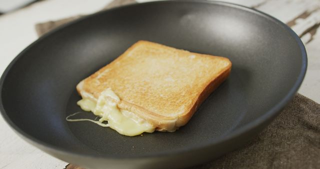 Image of freshly toasted cheese white bread sandwich prepared on frying pan. fusion food, breakfast and home made snack concept.