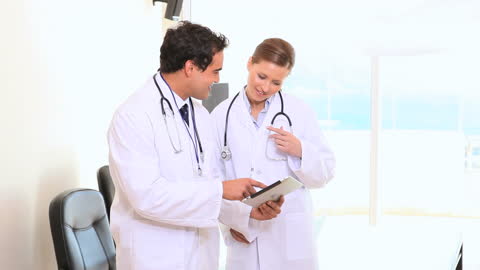 Doctors Collaborating Using Tablet in Medical Office