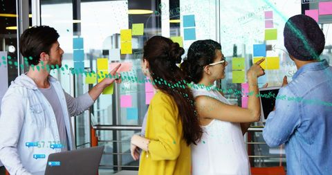 Diverse Team Collaborating with Data and Digital Interfaces in Modern Office