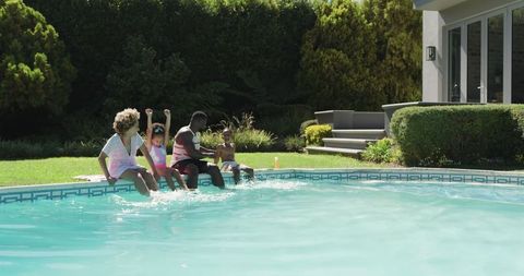 Family Enjoying Sunny Day by Backyard Swimming Pool