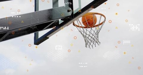 Sinking basketball through hoop with backboard support arm and digital analytics overlay