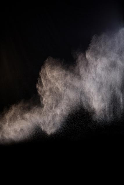 Splashing of dust powder on black background