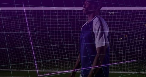 Nighttime soccer goalkeeper standing on turf with purple augmented data overlay and grid