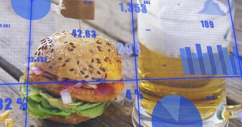 Seeded burger with beer and fries featuring blue data overlay, charts and infographic grid