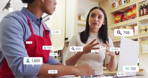 Small business owners discussing marketing analytics at cafe counter with overlays