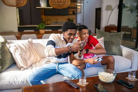 Diverse Friends Enjoying Video Gaming Session at Home
