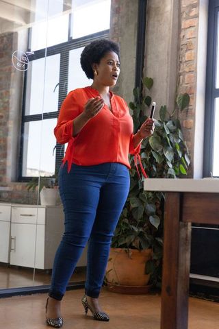 Confident African American Professional Presenting in Modern Office