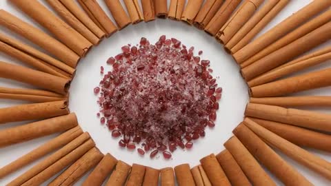 Overhead video showing cinnamon ring surrounding sugar-dusted pomegranate arils