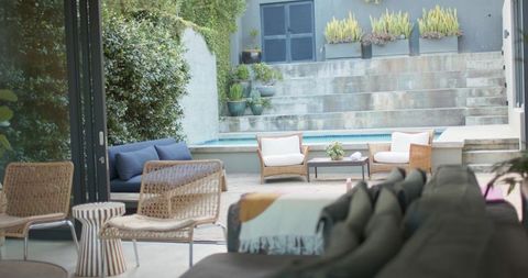 Modern outdoor courtyard featuring plunge pool, rattan lounge seating and neutral sectional