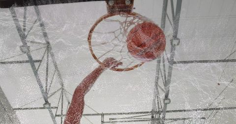 Basketball Scoring in Indoor Gym with Net and Ball Mid-Flight