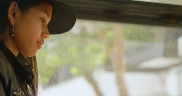 Thoughtful young woman sitting by window on rainy day - Download Free Stock Images Pikwizard.com