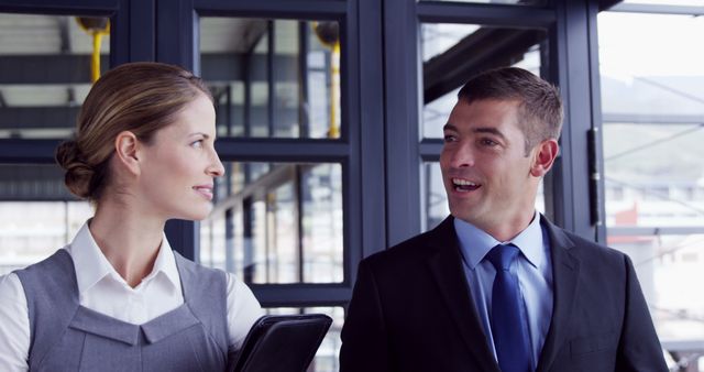 Professional colleagues discussing business in modern office building - Download Free Stock Images Pikwizard.com