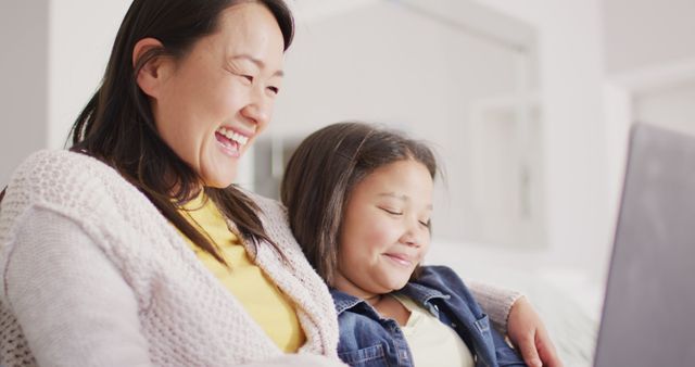 Smiling Mother and Daughter Watching Laptop at Home - Download Free Stock Images Pikwizard.com