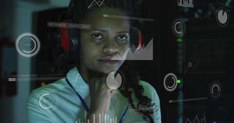 It specialist monitoring server analytics with headset and augmented data hud overlay