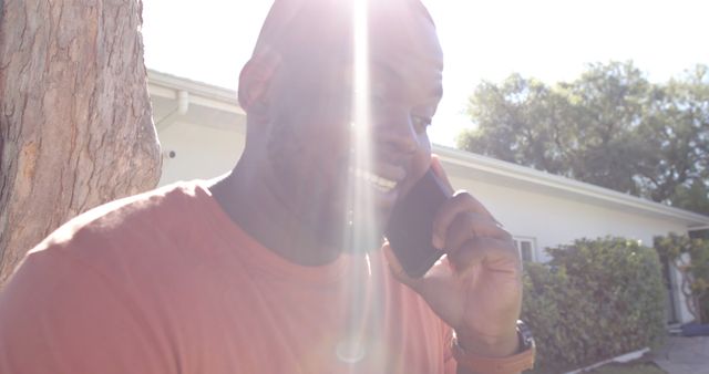 Smiling Man Talking on Phone Under Sunlight Outdoors - Download Free Stock Images Pikwizard.com