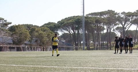 Soccer player dribbling ball during training on sunny day