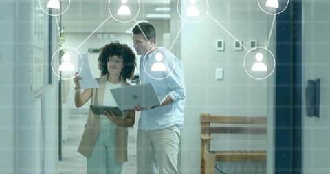 Business Professionals Collaborating on Project in Modern Office Environment