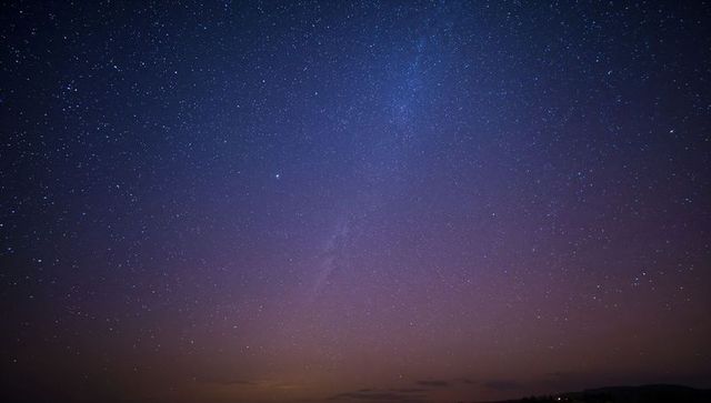 Milky Way Over Remote Hills at Twilight, Starfield Sky with Indigo to Purple Gradient