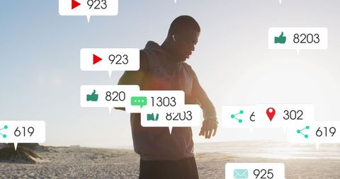 Athlete engaging with social media workout reminders on beach