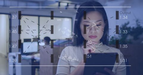 Young Professional Analyzing Data on Digital Tablet in Modern Office