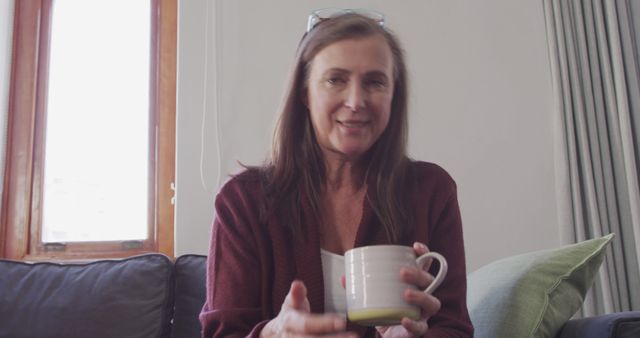 Middle-aged woman enjoying coffee at home - Download Free Stock Images Pikwizard.com