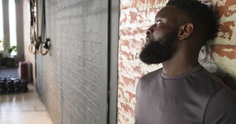 Athletic man observing in modern urban gym