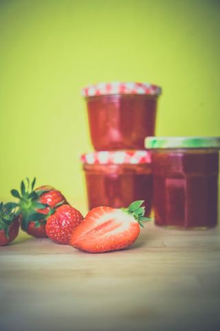 Homemade strawberry jam and fresh strawberries