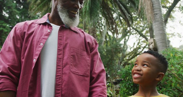 Grandfather and Grandson Smiling Together in Garden - Download Free Stock Images Pikwizard.com