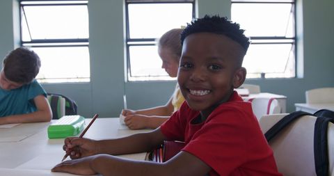 Smiling Boy With Classmates in Classroom Enjoying Learning - Download Free Stock Images Pikwizard.com