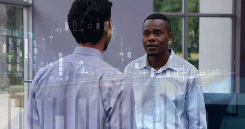 Diverse Businessmen Discussing Financial Strategies with Analytics Display