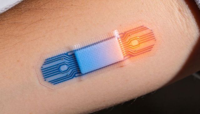 Flexible electronic skin patch with glowing led on inner forearm, wearable sensor