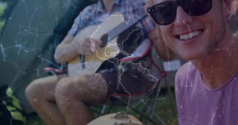 Smiling Young Man Enjoying Camping with Guitar and Cookout