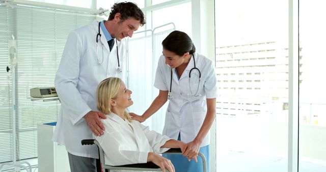 Medical team of doctor and nurse assisting a smiling female patient in wheelchair. Picture perfect for articles on patient care, hospital staff duties, healthcare services, and medical team collaboration. Great for illustrating trust between medical staff and patients, promoting compassionate healthcare, and enhancing clinic or hospital promotional materials.