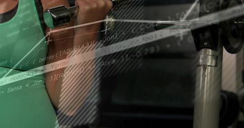 Female lifting dumbbell at shoulder with barbell and code overlay fitness tech concept