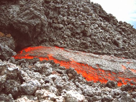 Flowing Lava through Rough Volcanic Rock Landscape