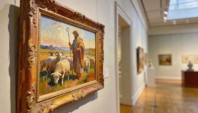 Gilded framed shepherd painting displaying on museum gallery wall with pastoral flock