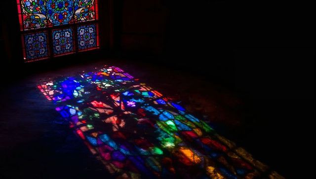 Colorful stained glass reflections inside historic chapel