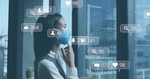 Contemplative woman wearing mask at high-rise window with social media overlay alerts