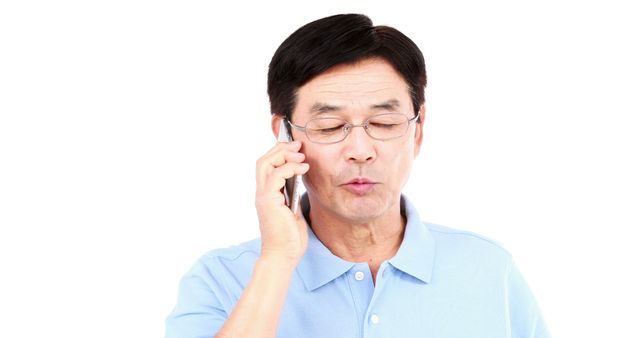 Middle-aged man with glasses talking on cellphone in casual attire - Download Free Stock Images Pikwizard.com