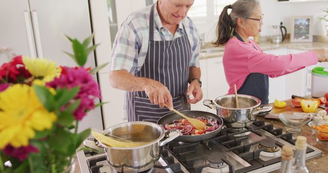 Happy Diverse Senior Couple Enjoying Cooking Together in Cozy Kitchen - Download Free Stock Images Pikwizard.com