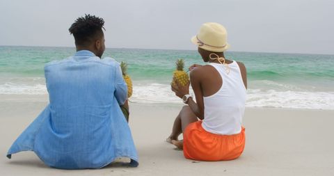 Couple Enjoying Pineapple Drinks on Beach Getaway