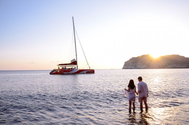 Couple Enjoying Sunset by Scenic Sea with Sailing Yacht - Download Free Stock Photos Pikwizard.com