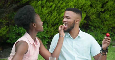 Romantic Couple Sharing Strawberries Outdoors Smiling Joyfully