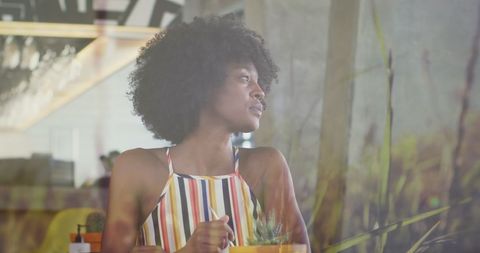 Thoughtful Woman Sitting in Trendy Restaurant