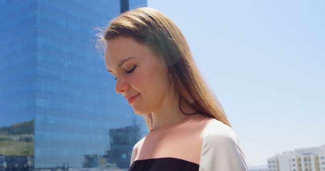 Thoughtful Young Woman Outdoors with Modern Architecture Background - Download Free Stock Images Pikwizard.com