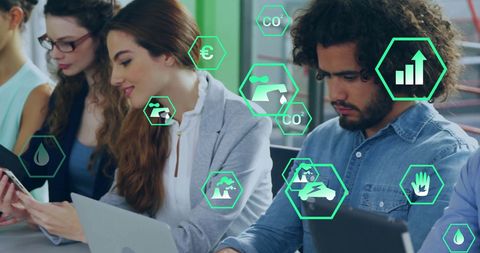 Diverse Colleagues Engaged in Eco-Tech While Using Digital Devices