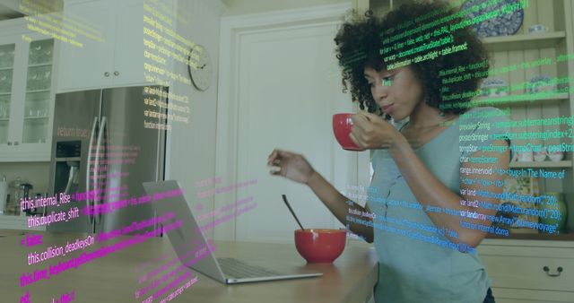 African American Woman Coding on Laptop While Drinking Coffee in Kitchen - Download Free Stock Images Pikwizard.com