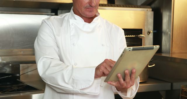 Senior Chef Using Tablet in Industrial Kitchen - Download Free Stock Images Pikwizard.com